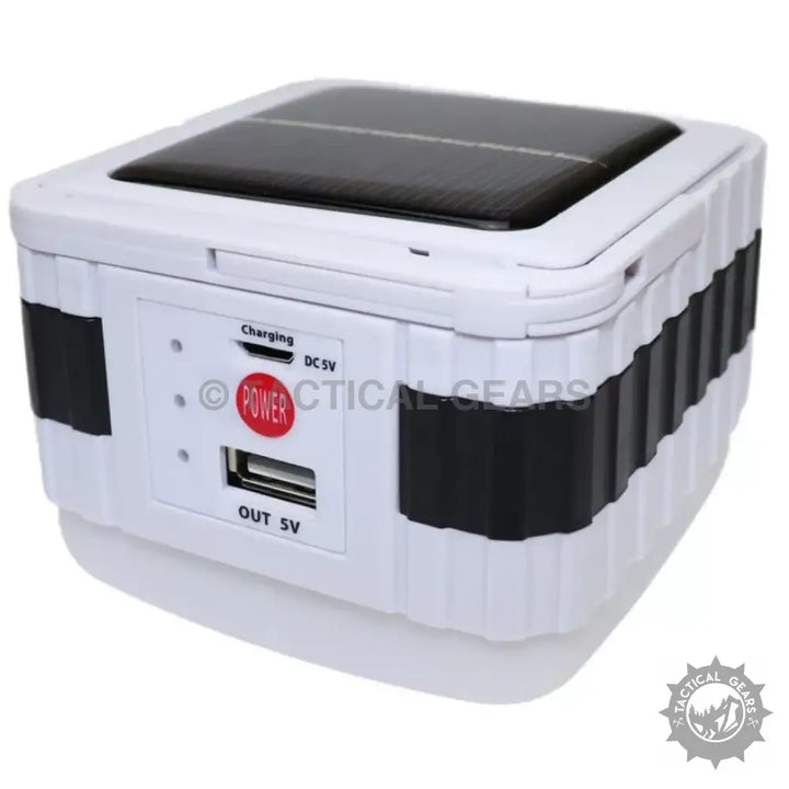 White portable solar powered camping lantern with USB charging output for outdoor use