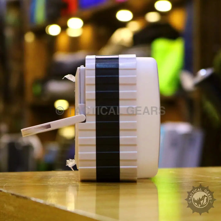 White and black portable adhesive roller for lint or pet hair on Solar Powered Camping Lantern