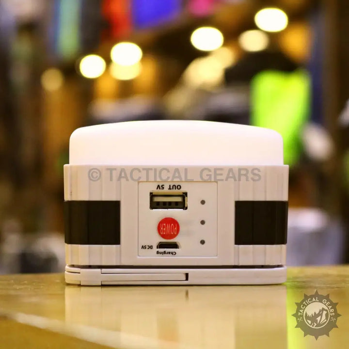 White solar powered camping lantern with USB output, power button, and charging lights