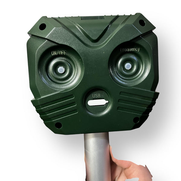 Dark green Solar Powered Outdoor Animal Repellent Device with adjustable frequency and controls