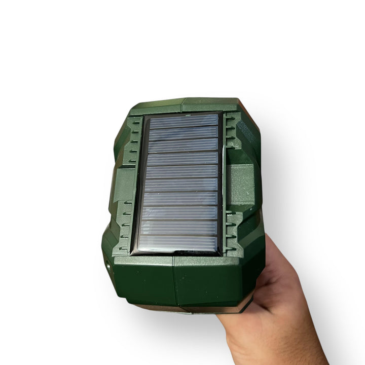Portable Solar Powered Outdoor Animal Repellent Device held in hand for pest control