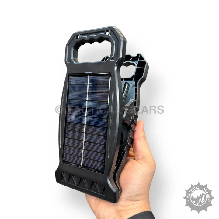 Black Solar Sensor Clip Work Light with handle and ribbed grip held by hand