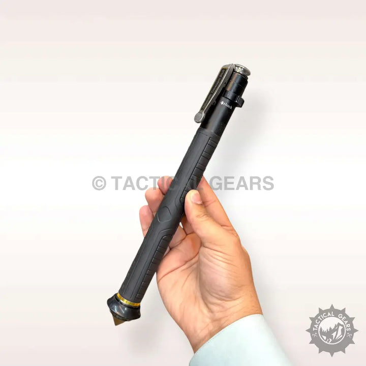 Hand holding a spring loaded self defence baton with black tactical pen and gold glass breaker