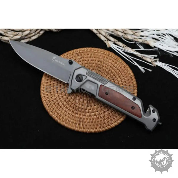 Gray folding camping knife with wood handle and textured grip, ideal for outdoor use