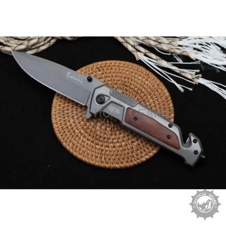 Gray folding camping knife with wood handle and textured grip, ideal for outdoor use
