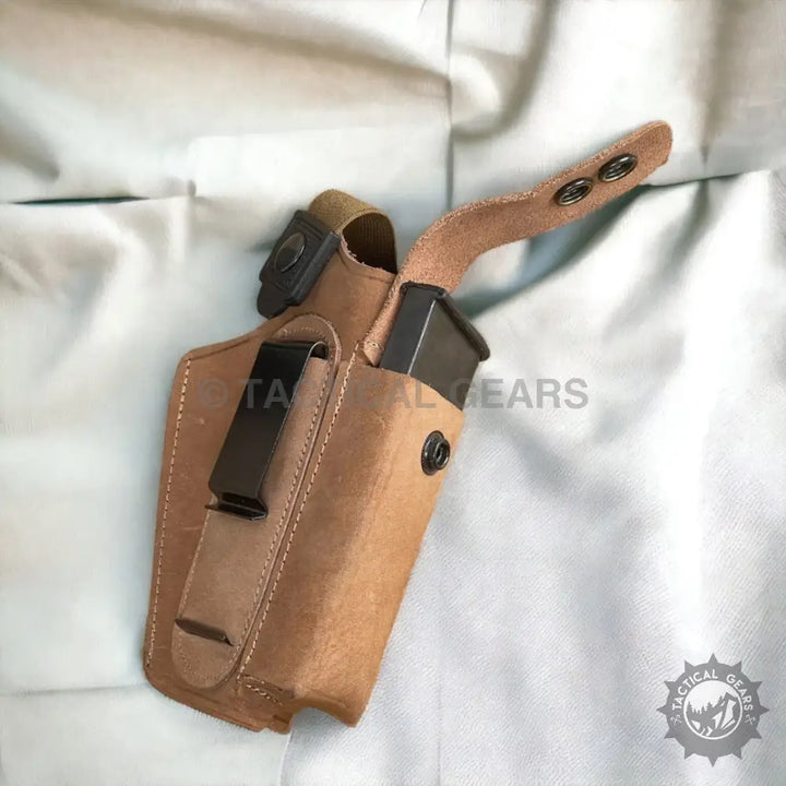 Light brown leather gun holster with magazine for 9mm and belt clip for left hand use
