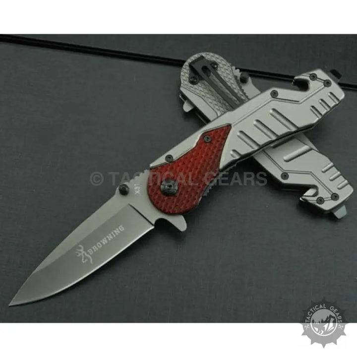 Browning X31 survival knife with silver and red blade handle and partial serrated blade