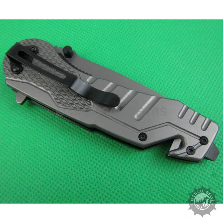 Gray Browning X31 survival knife with blade handle, pocket clip, and glass breaker
