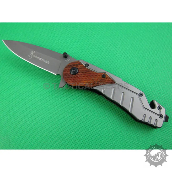 Browning X31 folding survival knife with gray blade and wood-metal handle