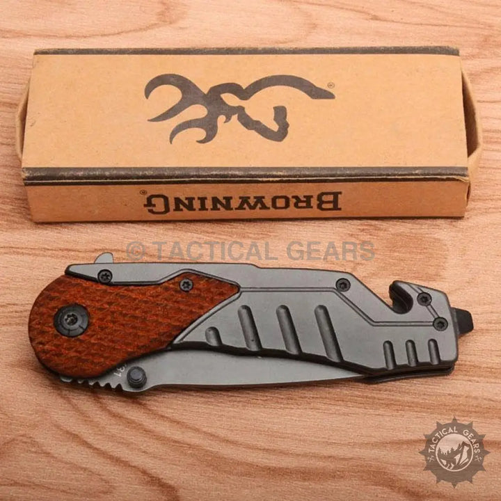 Browning X31 survival knife with folding blade, wooden handle, and built-in bottle opener