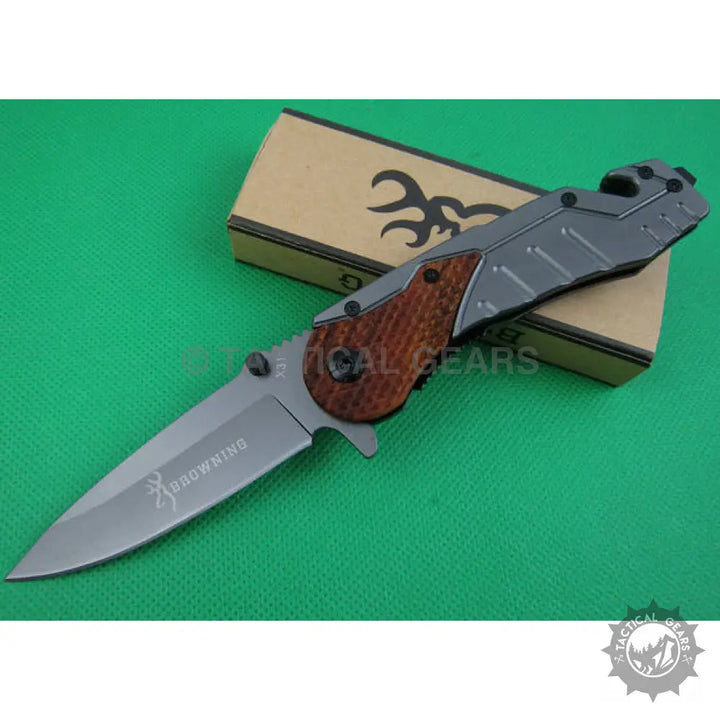 Browning X31 survival knife with silver blade, wooden handle accents, and gray frame