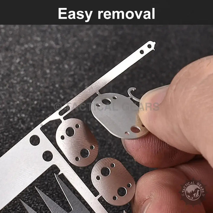 Metal components being separated by hand on 22-In-2 Survival Card with tool card functionality