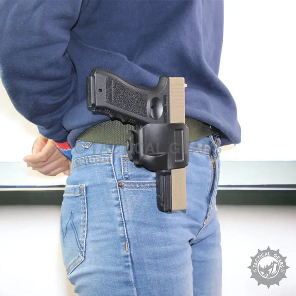 Black and tan pistol in a black tactical belt holster attached to a belt