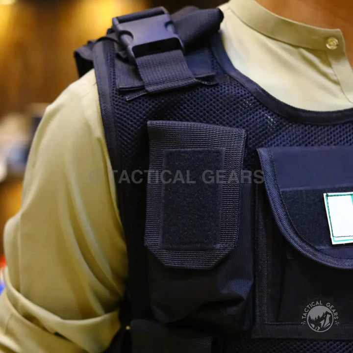 Black tactical vest with multiple pouches and buckle closure featuring armor plate integration