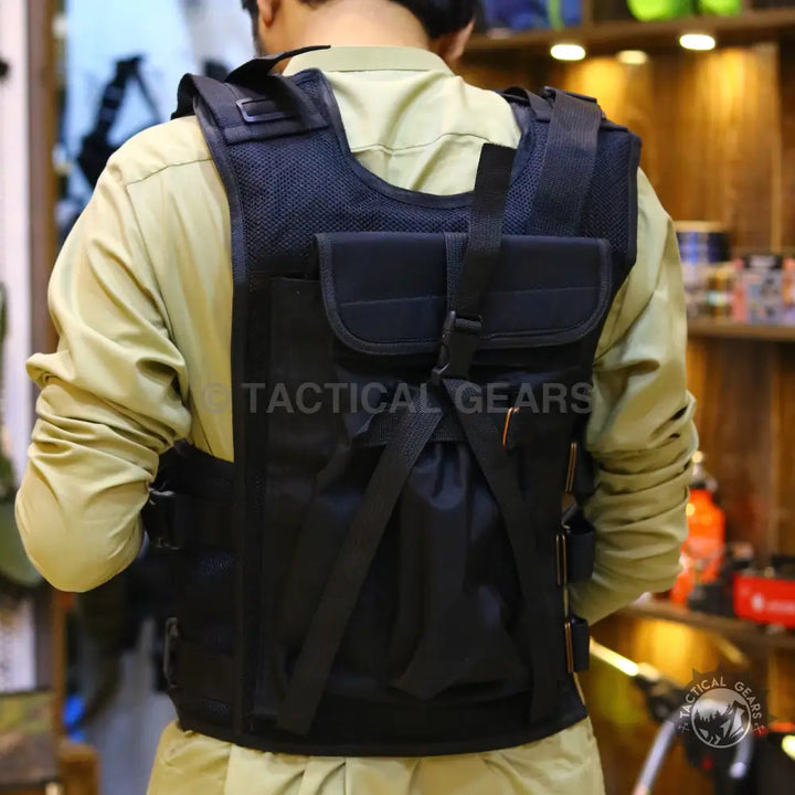 Black tactical vest with multiple pouches and adjustable straps featuring armor plate compatibility