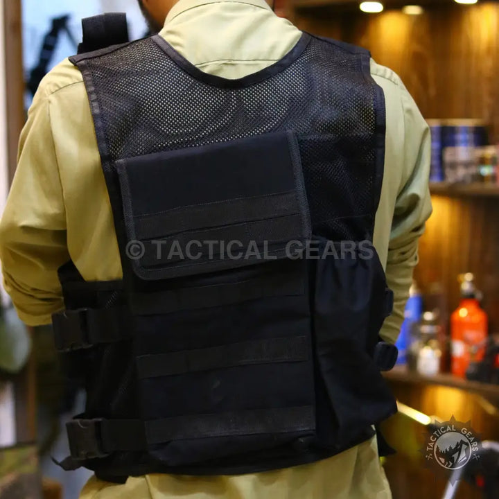 Black tactical military vest with mesh shoulders and multiple pockets for tactical military use