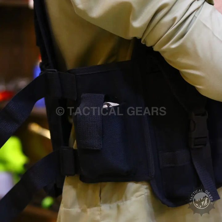 Black tactical military vest with armor plate pockets and multiple straps and buckles