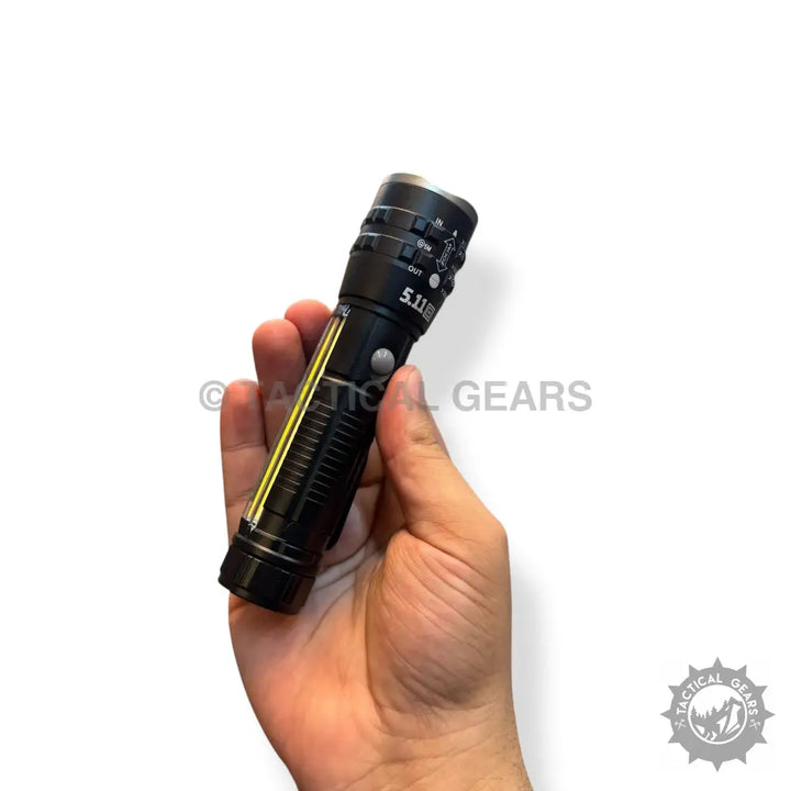 Black tactical pocket flashlight with yellow side strip showcasing 1km range in hand