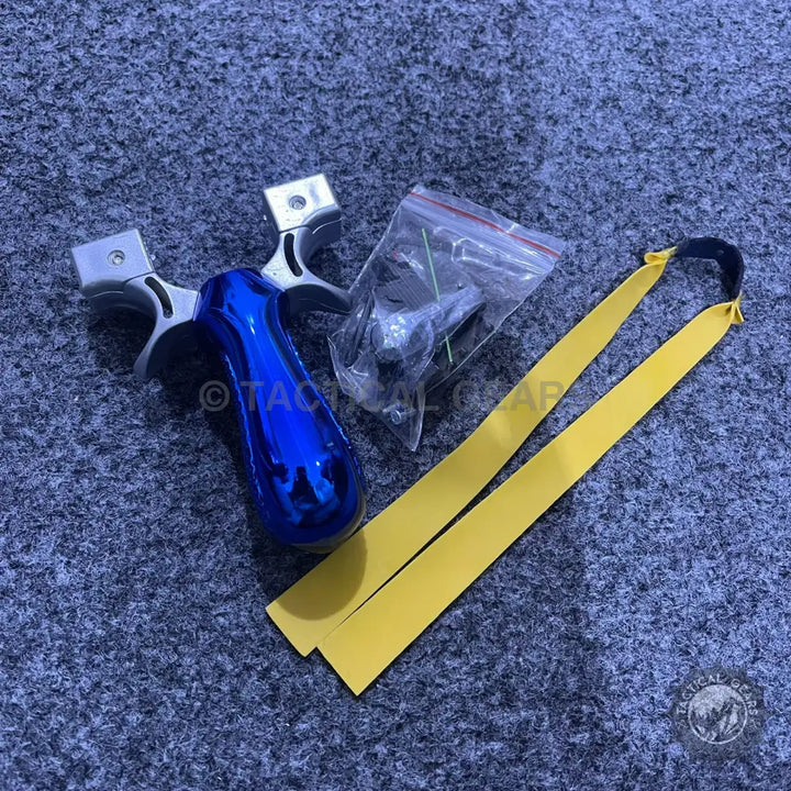 Blue and silver tactical resin slingshot with laser sight and accessories