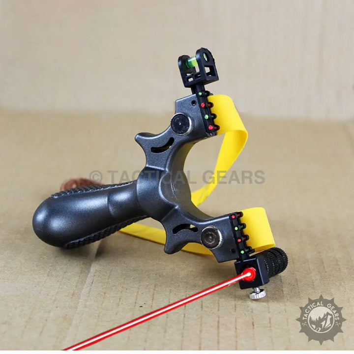 Black tactical resin slingshot with yellow bands and attached laser sight for precision shooting