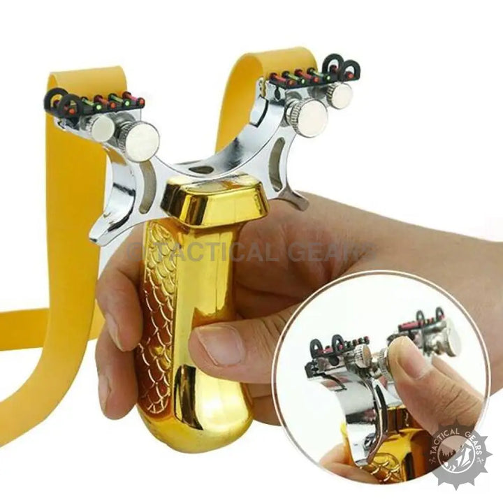 Metallic gold and silver tactical resin slingshot with yellow bands and laser sight