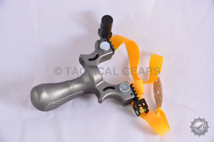 Gray metal tactical resin slingshot with laser sight and textured grip
