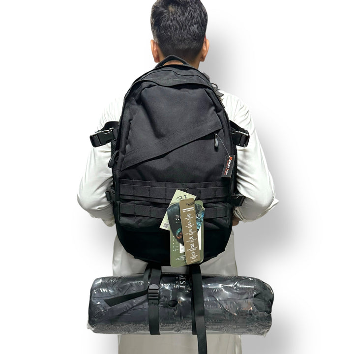 Black tactical backpack with rolled item attached, part of American Lot imported tactical gear