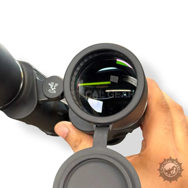 Black binoculars with open objective lens cover showcasing textured grip Optical 10x50 Binocular