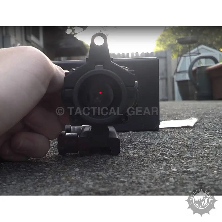 Black Trijicon ACOG 4x32 scope with red reticle mounted on a base