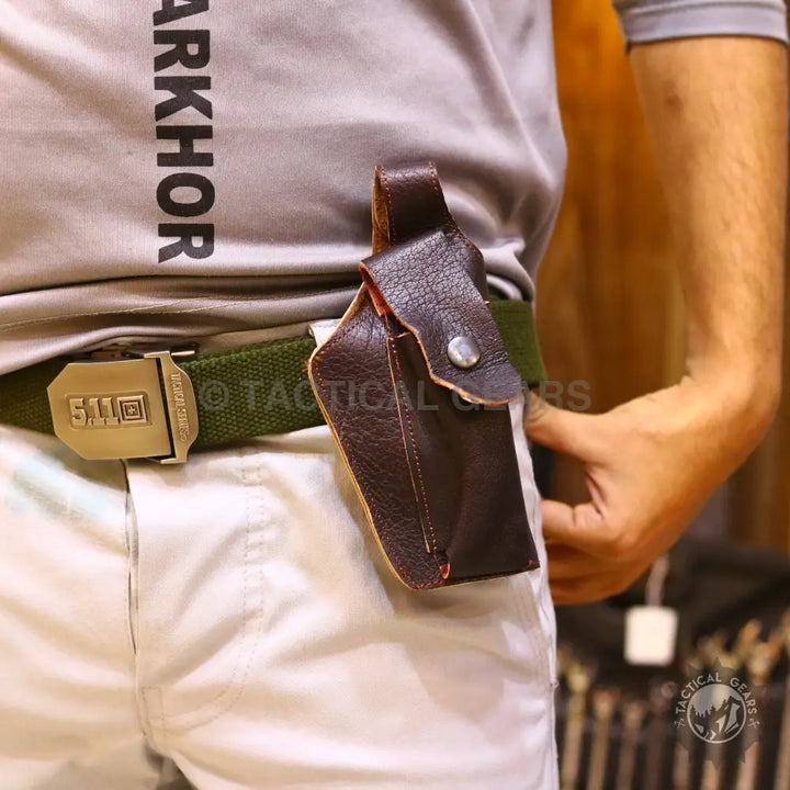 Brown leather pouch attached to a green tactical belt in a universal belt holster