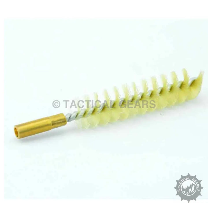 Tactical gear cleaning brush with yellow bristles in tool kit
