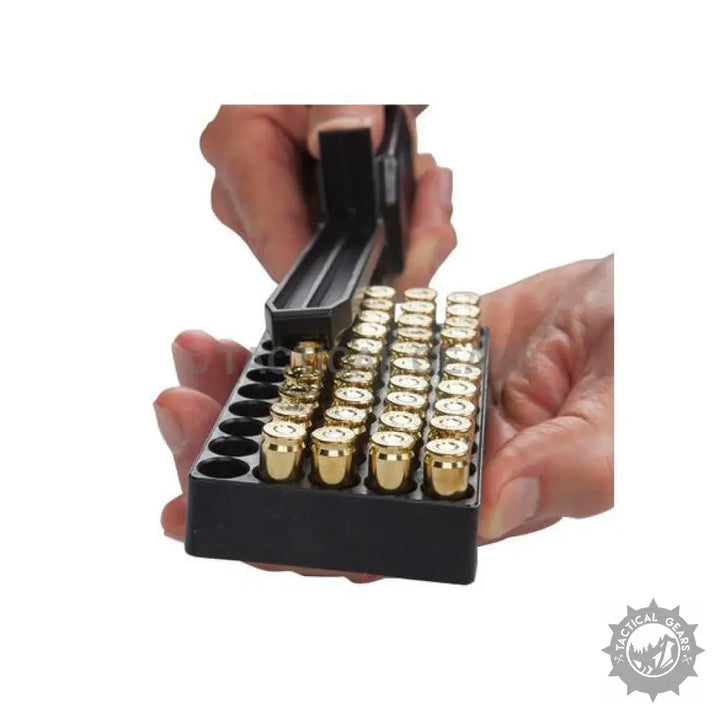 Person loading pistol cartridges with a universal magazine speed loader for quick reloading