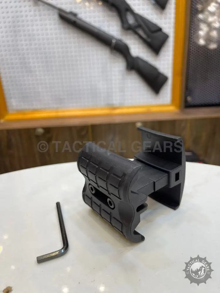Black tactical foregrip with textured panels and L-shaped hex key for universal rifle magazine coupler