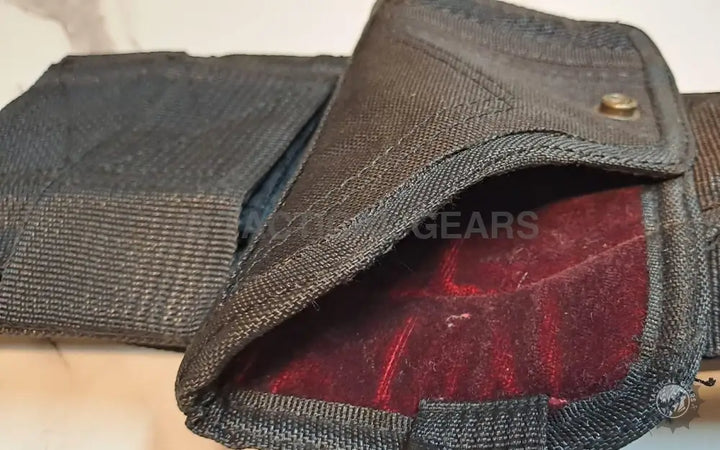 Dark gray fabric holster with a red velvet interior for versatile concealment