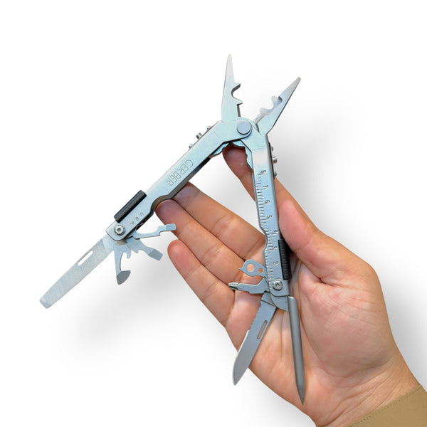 Silver USA Multifunctional Plier Tool with fold-out knives, pliers, and ruler in hand
