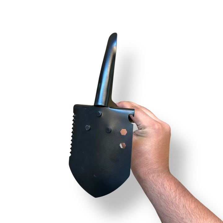 Black multi-purpose folding shovel with serrated edge and hex wrench holes for outdoor use