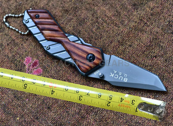 Small Buck USA X59 Tactical mini folding knife with dark wood handle and grey blade