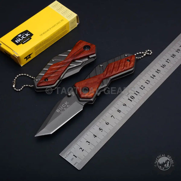 Two Buck USA X59 Tactical mini folding knives with wood-grain handles and ruler