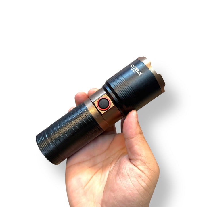 Hand holding a black and bronze USB Charging LED Tactical Flashlight with red button