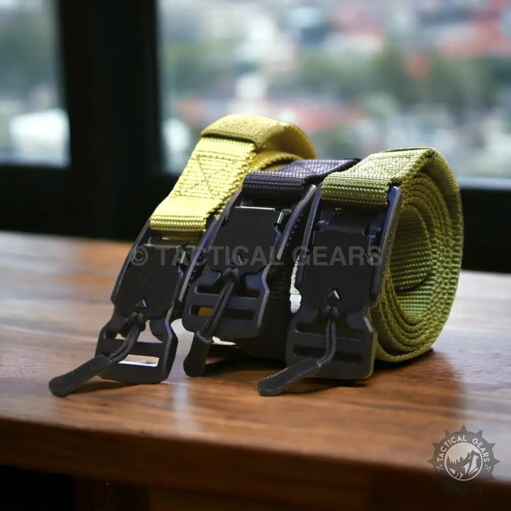 Three rolled tactical web belts with durable black buckles for outdoor and military use