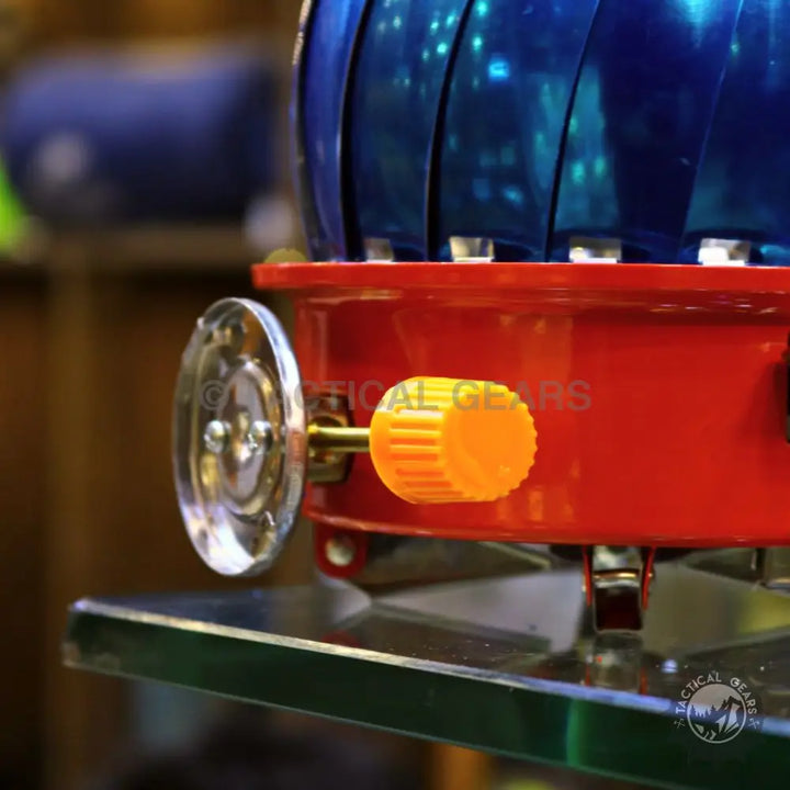 Red and blue wind-up toy train engine with orange knob for Windshield Lotus Camping Stove