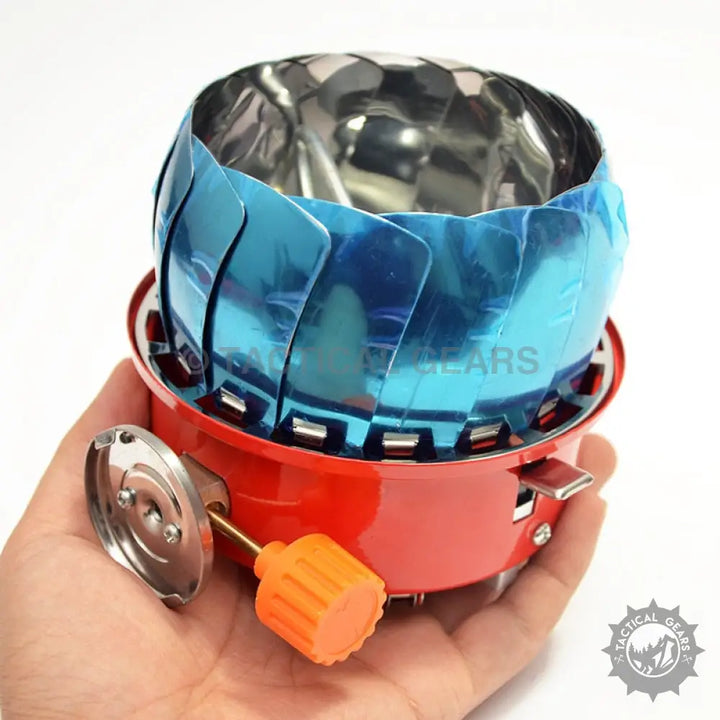 Compact red Windshield Lotus Camping Stove with blue wind guard and orange control knob