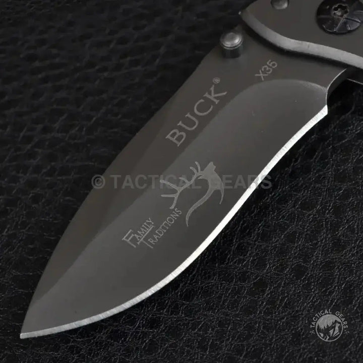 Dark gray folding pocket knife with partial serrated edge in Buck Drop-Point Pocket Knife X35