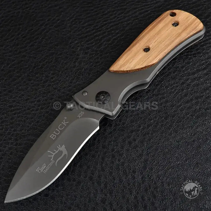 Buck Drop-Point Pocket Knife X35 with dark gray blade and light brown wooden handle