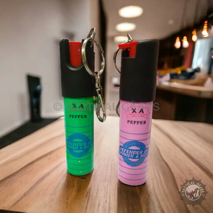 XA Self-defense Pepper Spray keychain canisters in green and pink for personal safety