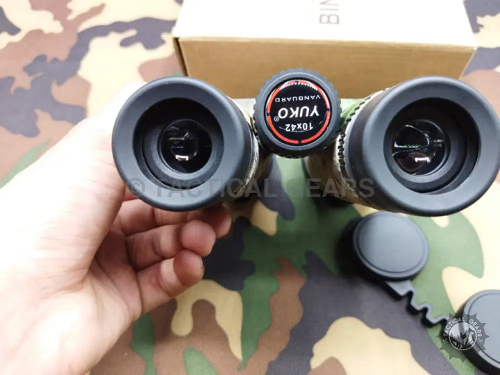 Camouflage-patterned Yuko Binoculars with black eyecups and lens covers for outdoor use